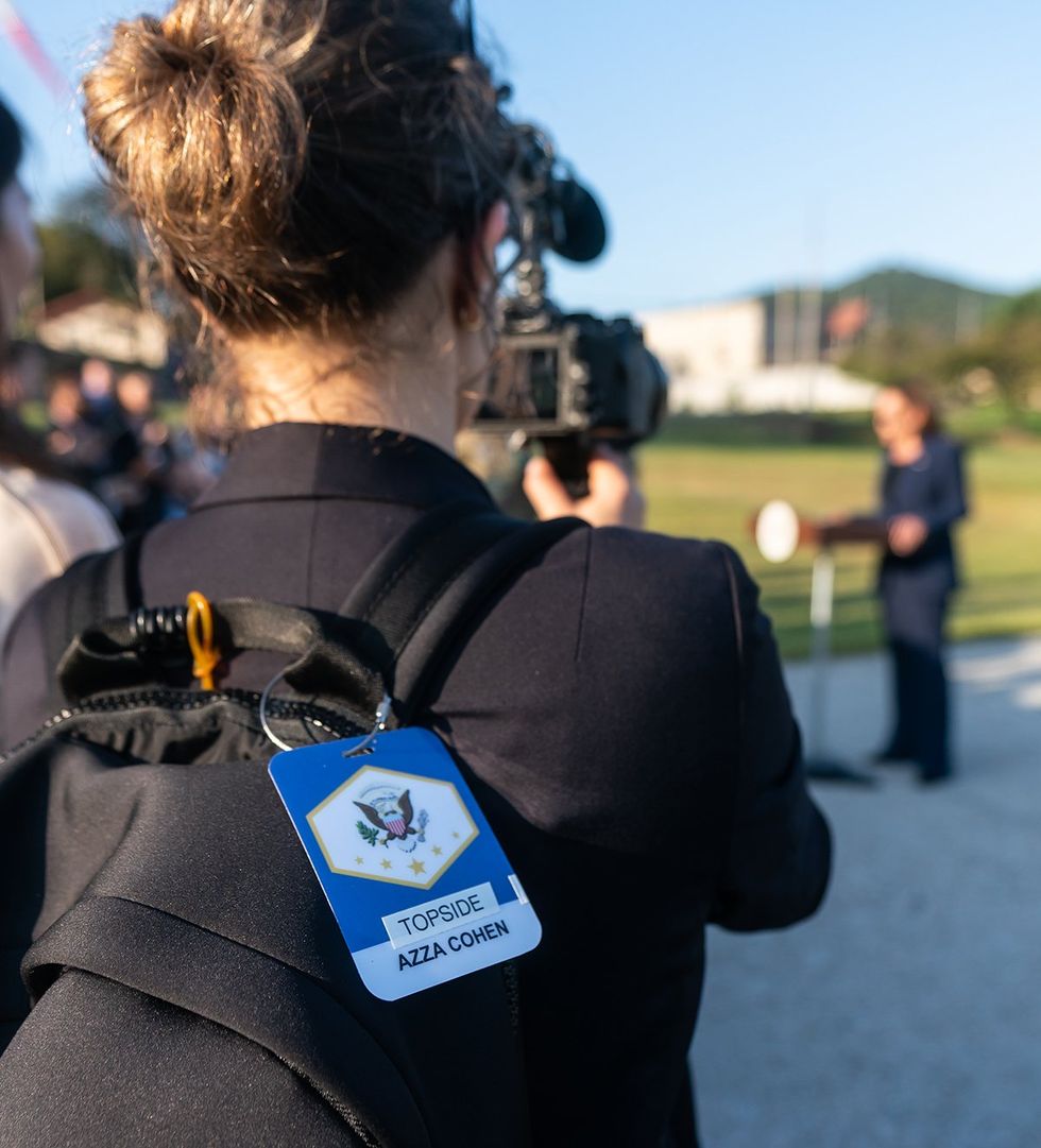 Azza Cohen filming Kamala Harris from behind with focus on bag tag
