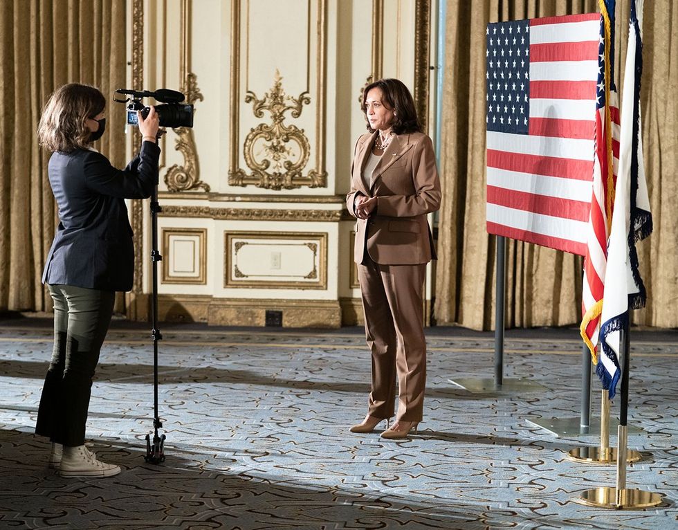 Azza Cohen filming Kamala Harris in front of american flag