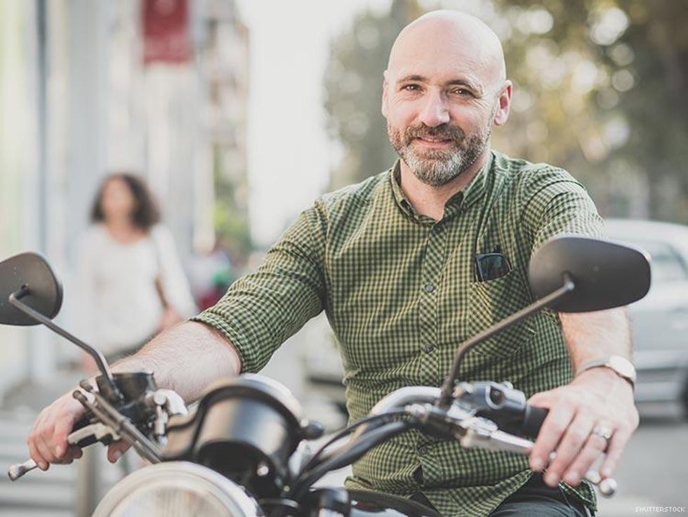 bald bearded man on motorcycle