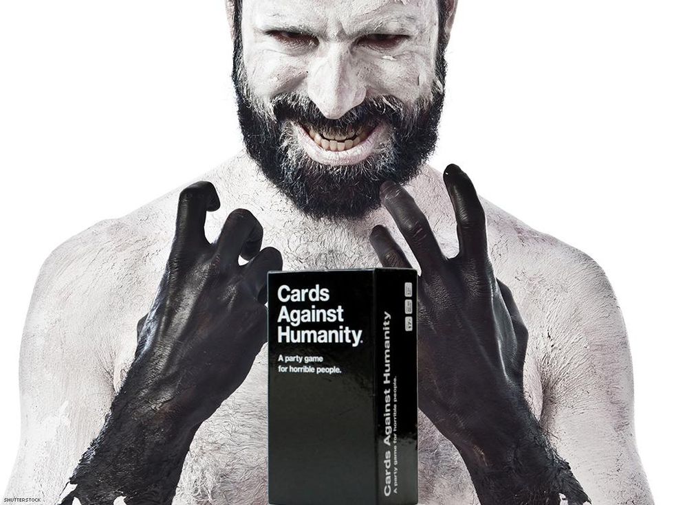 bearded man with gloves and cards against humanity game