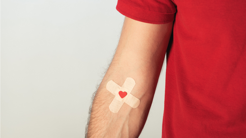 Blood donation concept art of man with bandage on his arm