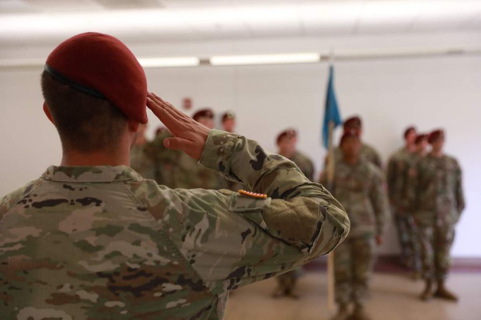 Brian Femminella salutes a group of soldiers