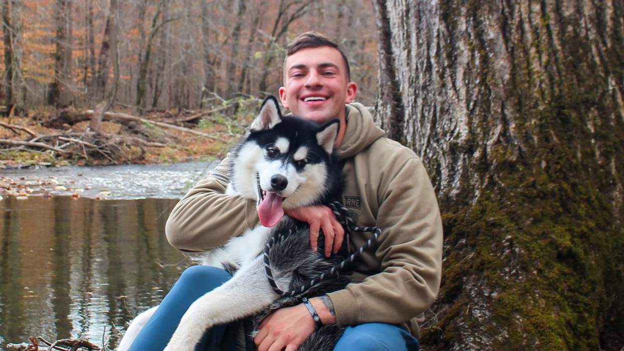 Brian Femminella with his dog near a creek