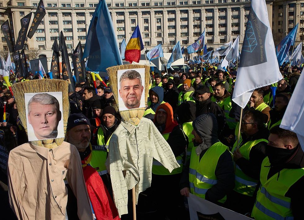Bucharest Romania 2025 Portraits on brooms Catalin Predoiu Minister of Internal Affairs Marcel Ciolacu Prime Minister of Romania during police officers protest