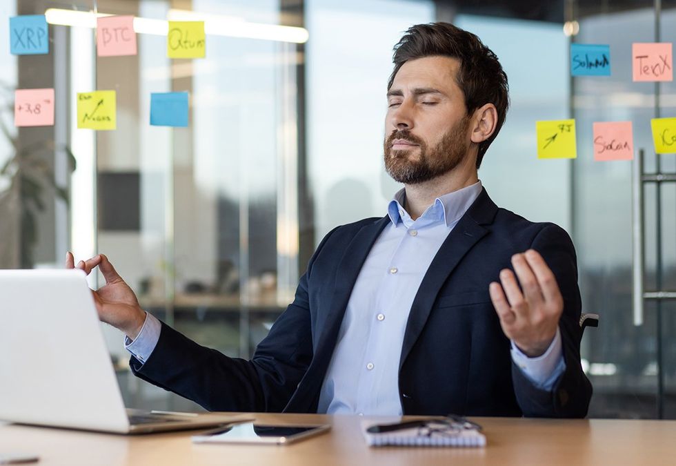 Businessman practicing meditation at desk