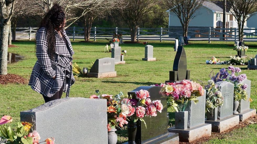 Camika Shelby visits the grave of her son.