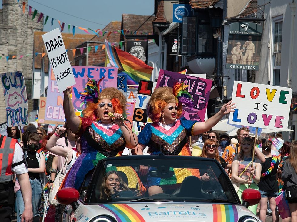 Canterbury Kent United Kingdom 2023 pride parade drag queens car float marchers with signs drag is not a crime love is love