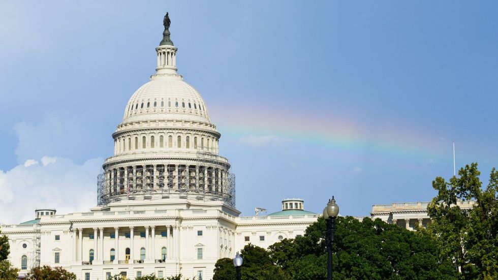 Capitol building with rainbow over it