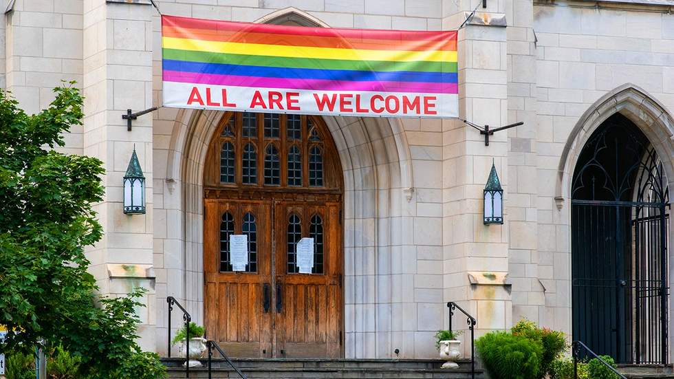 Church in Washington DC with all are welcome rainbow flag sign