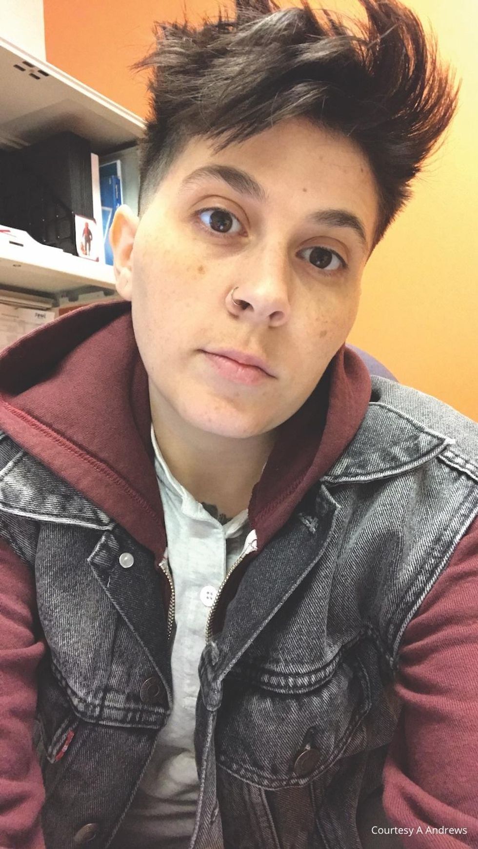 Close up of Author A. Andrews wearing a hoodie and vest