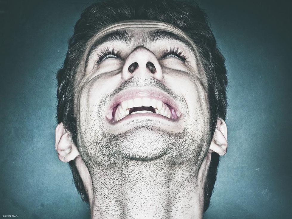 closeup mans face grunting and looking up