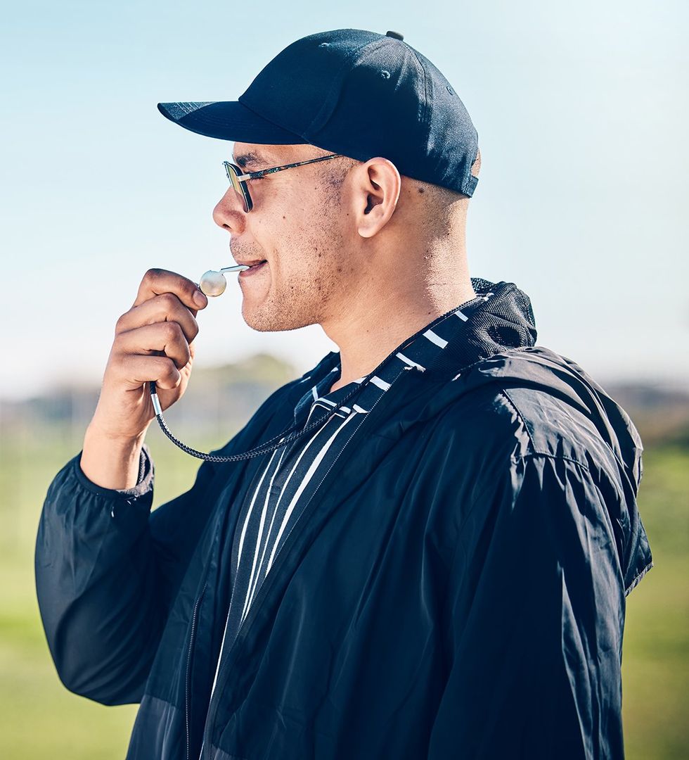 coach blowing a whistle