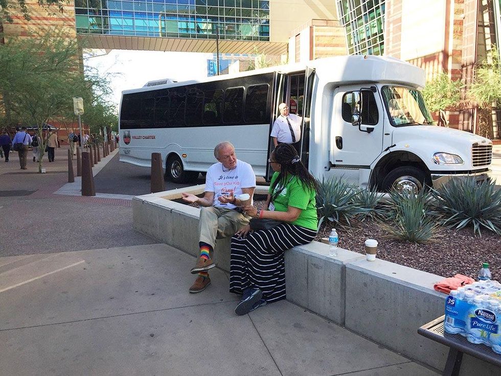 Coalition members speak with attendees of the Southern Baptist Convention meeting in front of the Phoenix Convention Center.