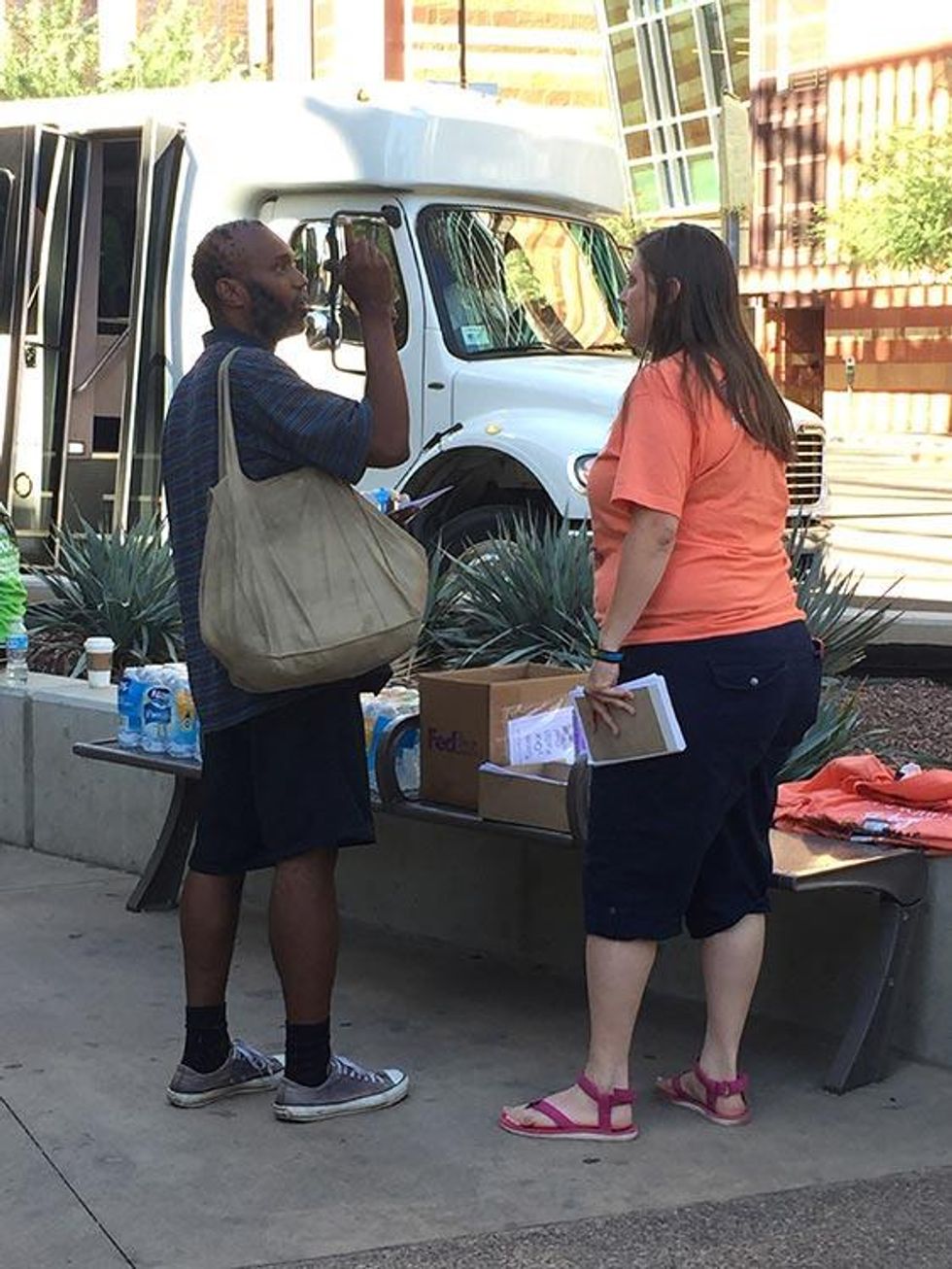 Coalition members speak with attendees of the Southern Baptist Convention meeting in front of the Phoenix Convention Center.