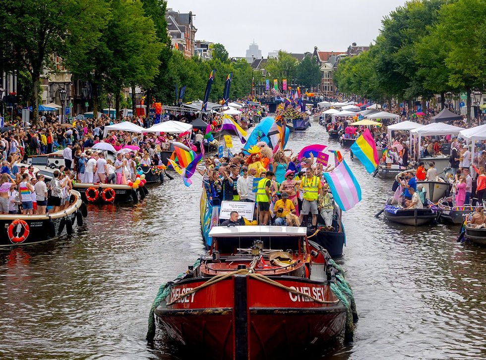 colorful parade boat in canal 2023 LGBTQ annual festival AMSTERDAM THE NETHERLANDS
