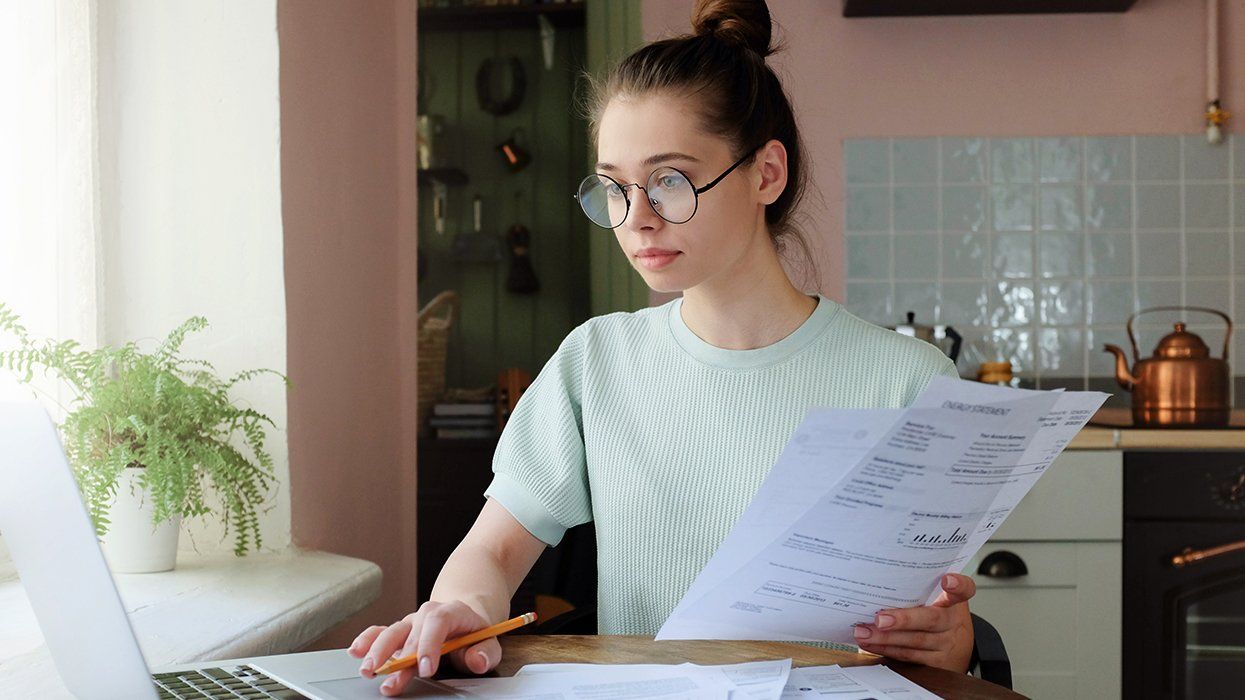 concerned young LGBTQIA person working on finances