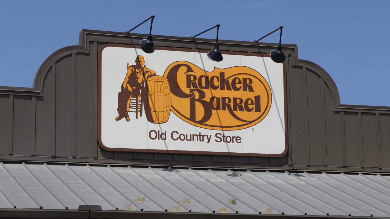 Cracker Barrel store sign on a building with blue sky in the background.