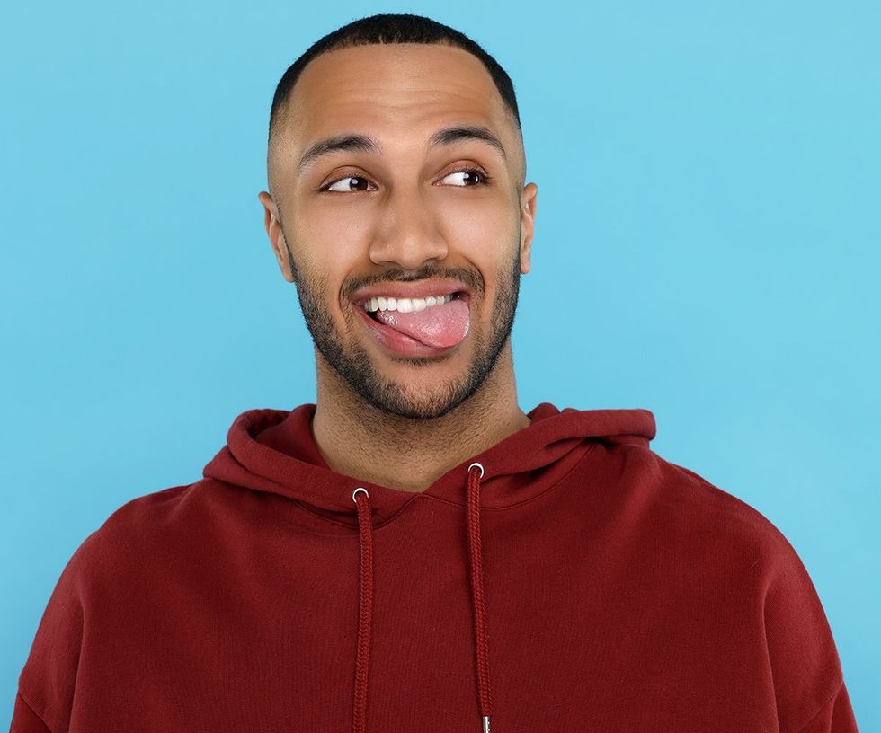 cute bearded guy with tongue out red hoodie against blue background