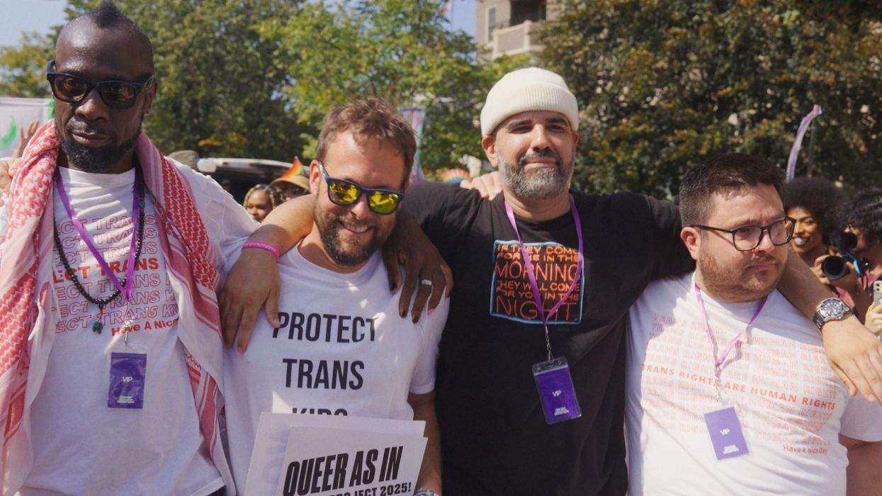 dads wearing supportive messages on their shirts about trans kids