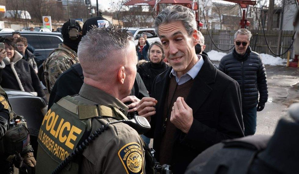 Daniel Biss speaks with Border Patrol Agent Greg Bovino.