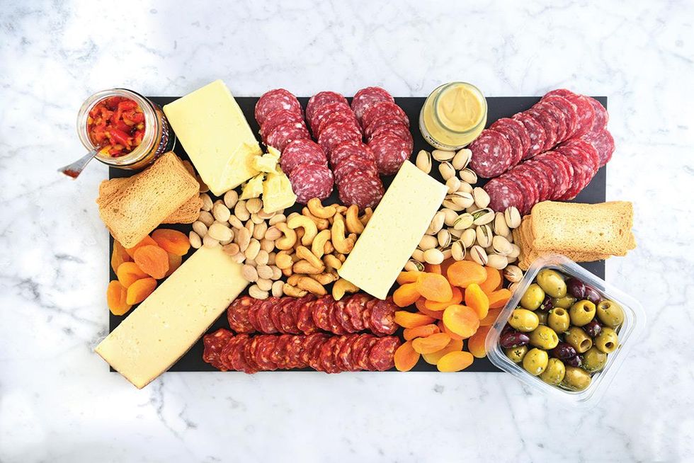 DeLallo\u2019s delicious Gourmet Charcuterie and Cheeseboards come already artfully arranged on a slate serving tray. ($35 and up, DeLallo.com)