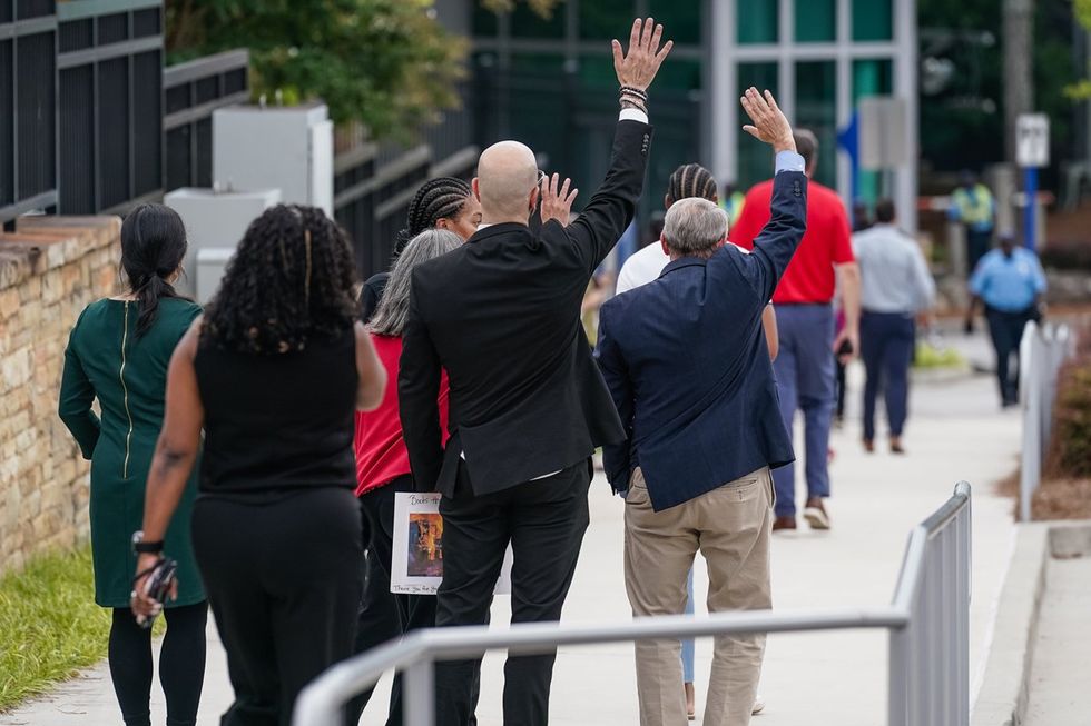 Demetre Daskalakis and others wave at crowd supporters