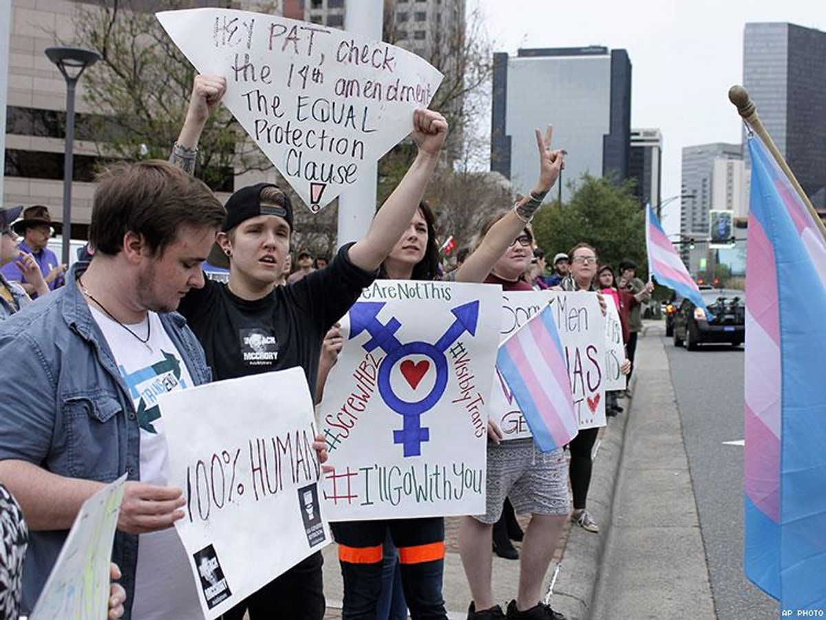 Demonstrators protesting passage of legislation limiting bathroom access for transgender people stand in front of the Charlotte-Mecklenburg Government Center in Charlotte.