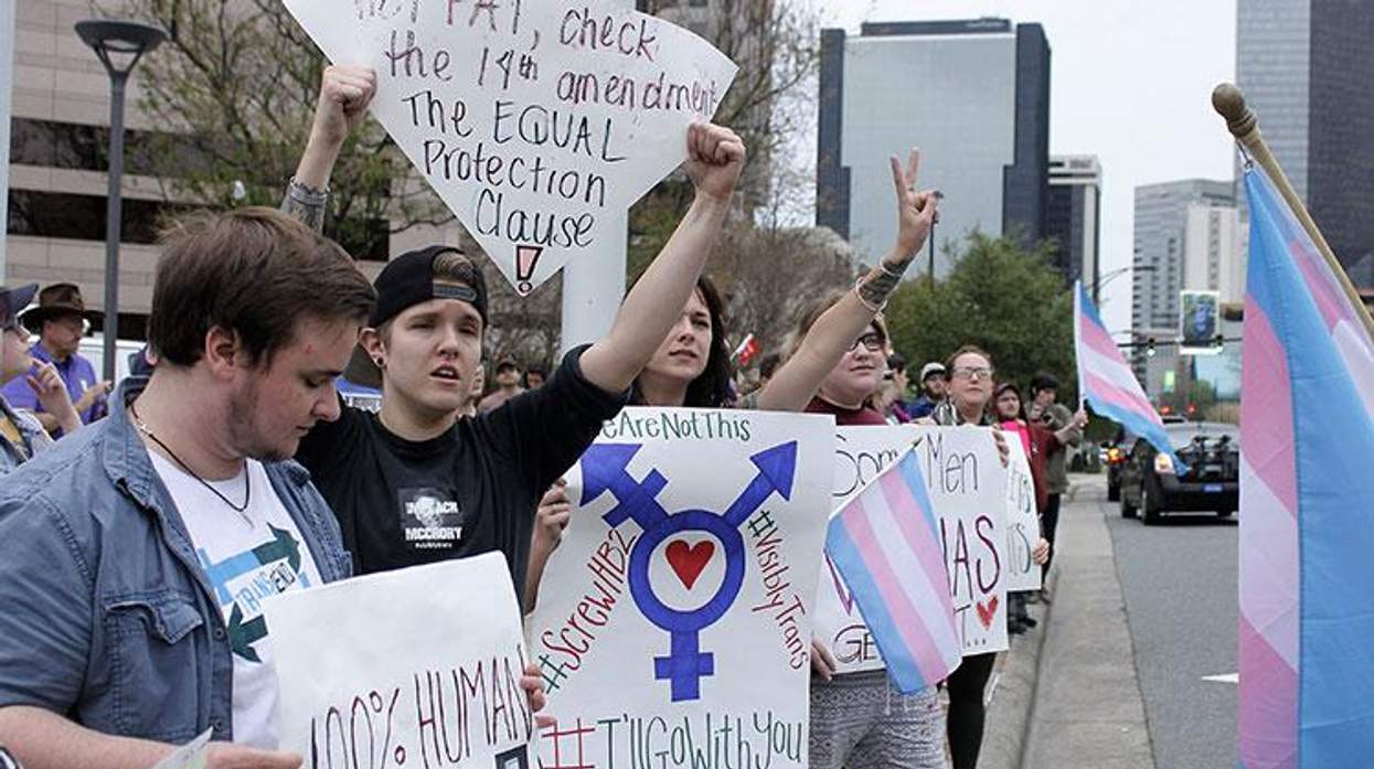 Demonstrators protesting passage of legislation limiting bathroom access for transgender people stand in front of the Charlotte-Mecklenburg Government Center in Charlotte.
