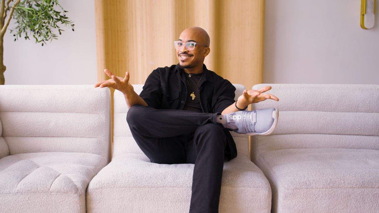Deshaun Armbrister smiling while seated on a couch