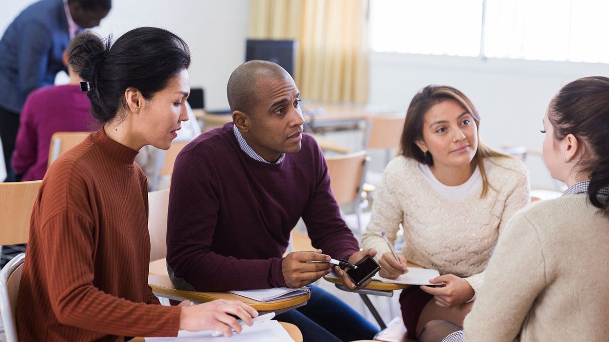 diverse group of concerned collaborative parents and teachers at school board meeting