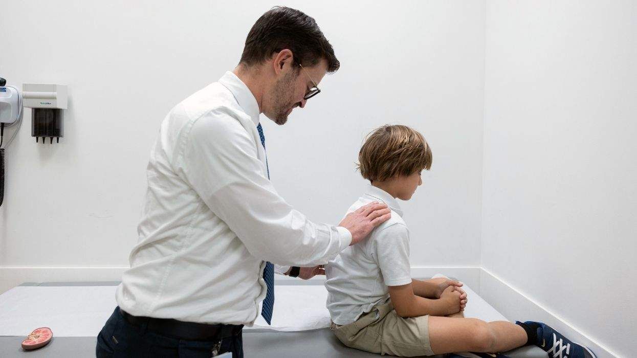 doctor examines child patient