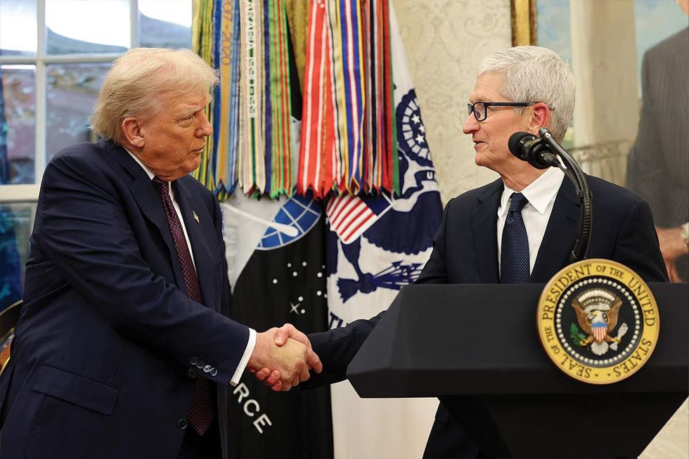 Donald Trump and Tim Cook shaking hands at a White House event