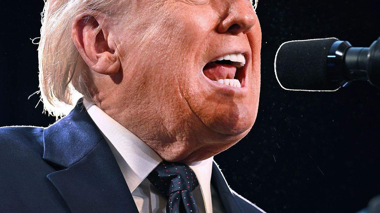 donald trump, cut off from the mid-nose down, speaking into a microphone