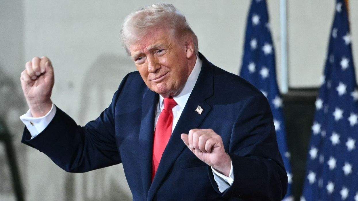 donald trump dancing with u.s. flags behind him