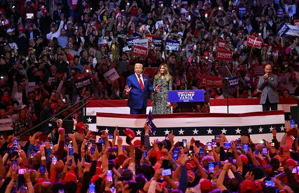 Donald Tump rally madison square garden NYC with wife melania surrounded by crowd