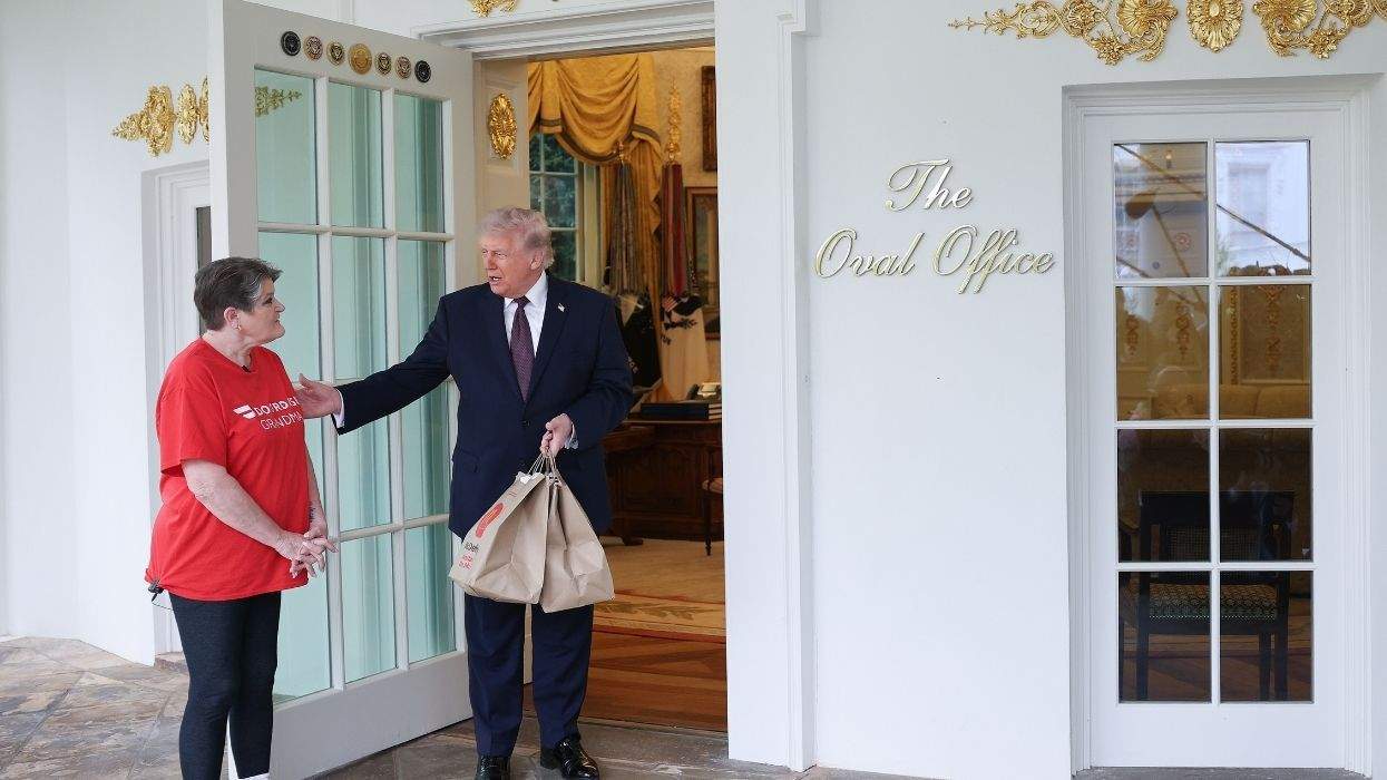 doordash driver sharon simmons with donald trump who is holding mcdonald's delivery bags.