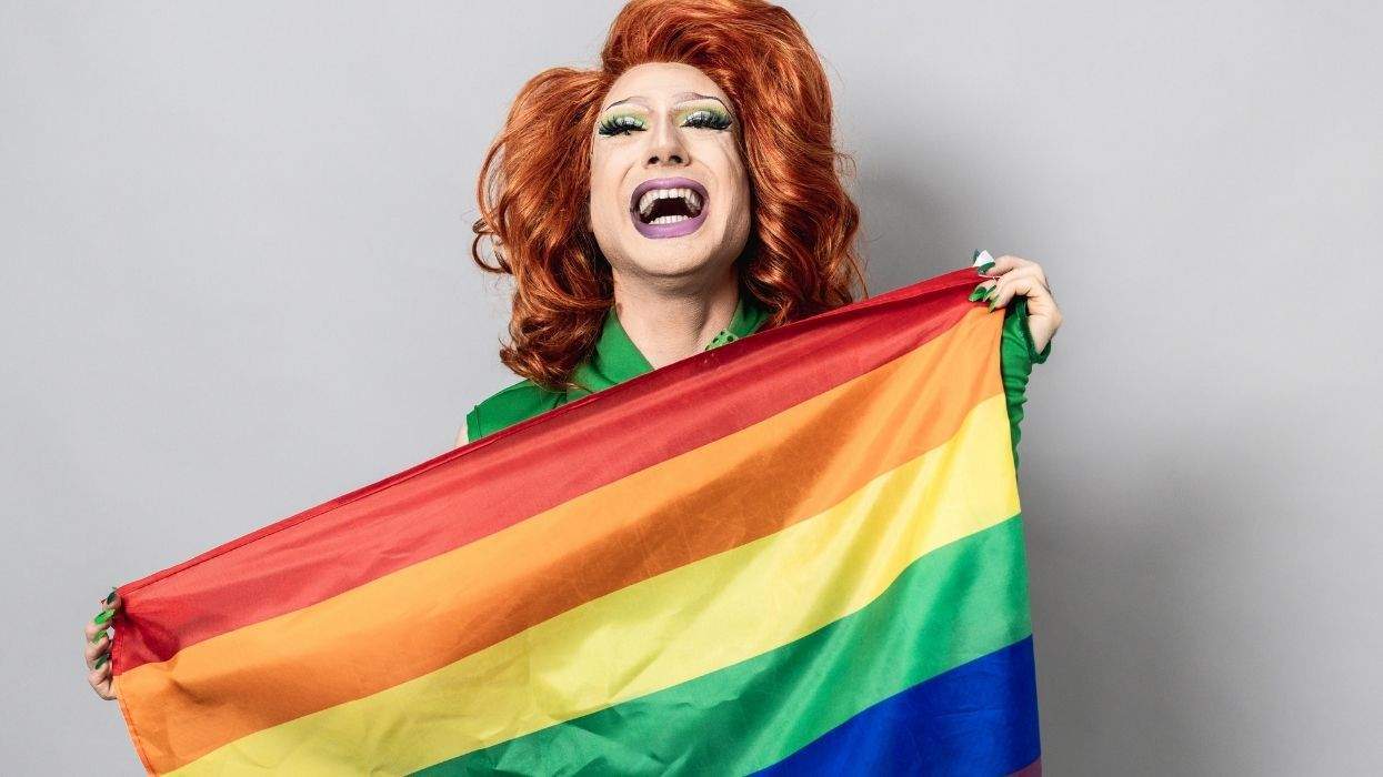 drag artist with pride flag