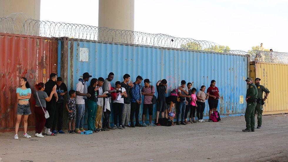 Eagle Pass Texas USA Border Patrol agents migrants seeking asylum taken into custody under International Bridge