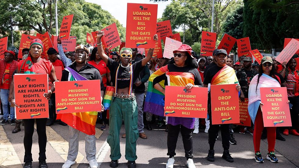 Economic Freedom Fighters leader Julius Malema (2nd R) Uganda queer activist Papa De (C-L) picketing protesting anti homosexuality bill outside high commission Pretoria South Africa
