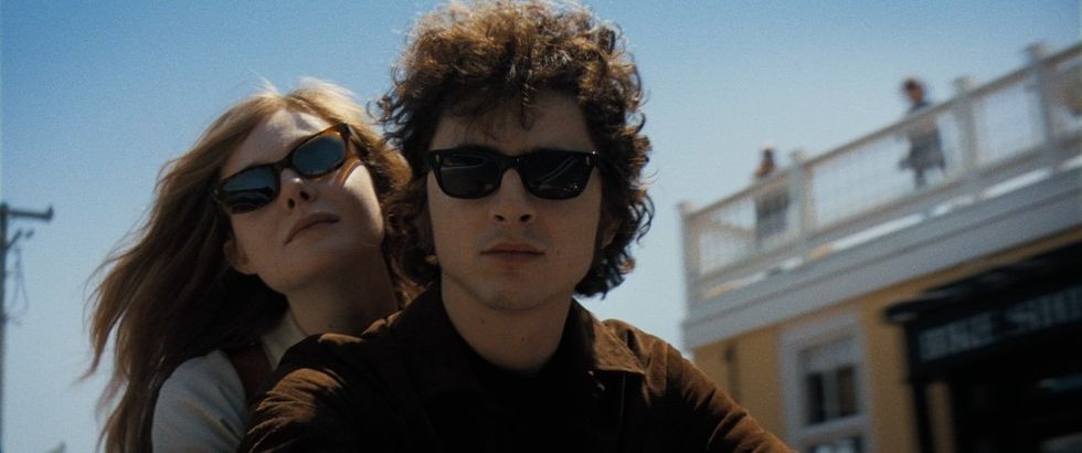Elle Fanning as Sylvie Russo and Timoth\u00e9e Chalamet as Bob Dylan in A Complete Unknown