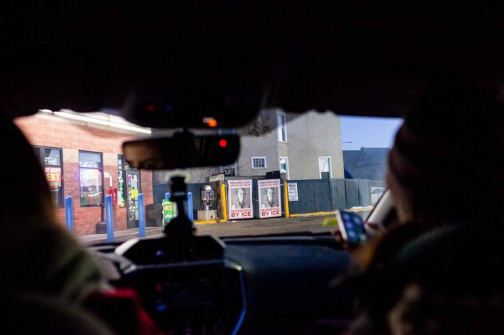 Elle Neubauer and another observer drive past wheat-pasted posters of Renee Good while on an early morning watch observing ICE in South Minneapolis Monday, Jan. 12, 2026.