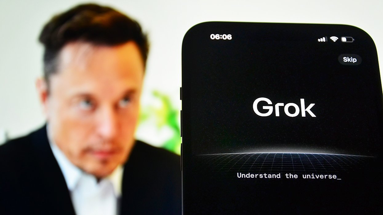 elon musk in soft focus and cellphone displaying Grok AI software app