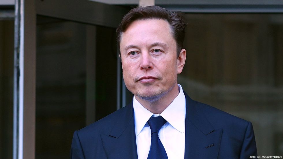 Elon Musk pictured in suit and tie