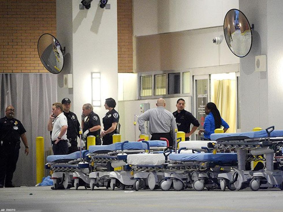 Emergency personnel wait with stretchers at the emergency entrance to Orlando Regional Medical Center hospital for the arrival of patients from the scene of the fatal shooting at Pulse Orlando nightclub.