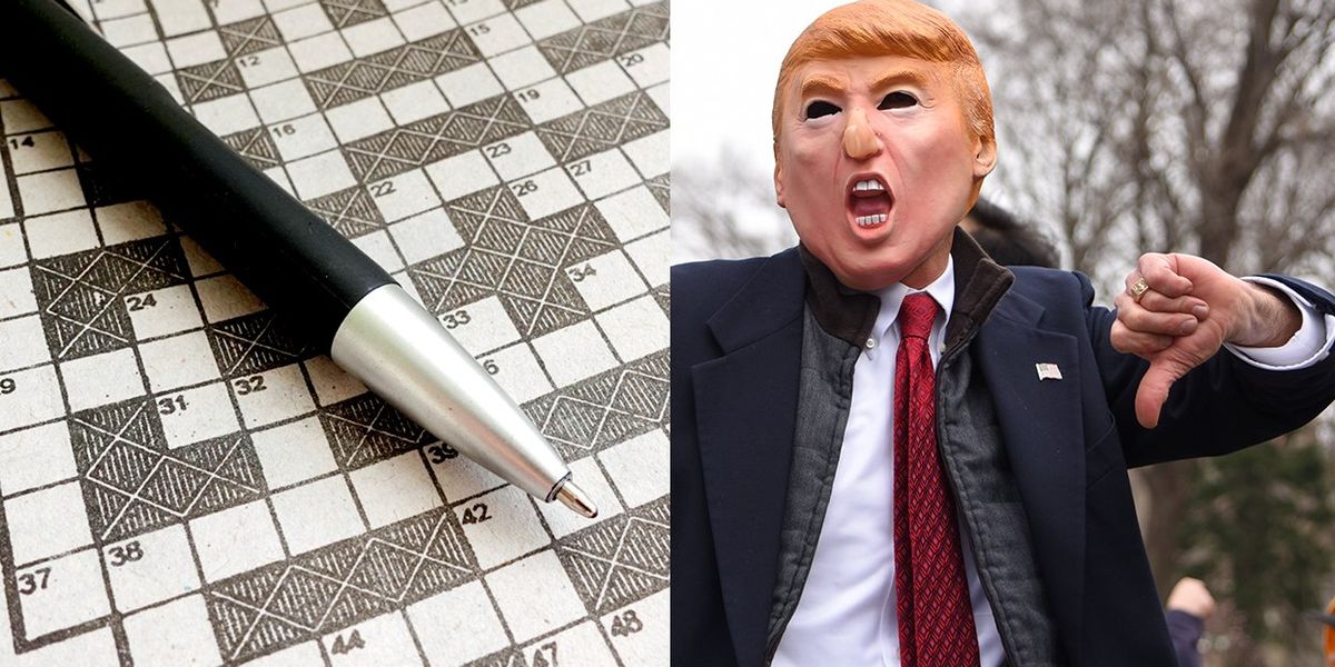 A person in a Donald Trump mask giving a thumbs down next to an empty crossword puzzle