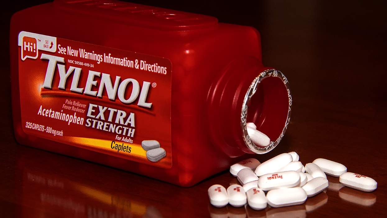 extra strength tylenol bottle and pills on a table