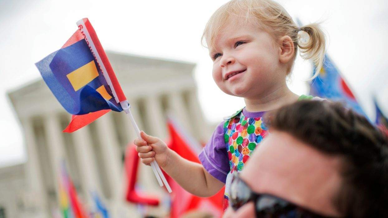 father with daughter holding hrc flag at the supreme court