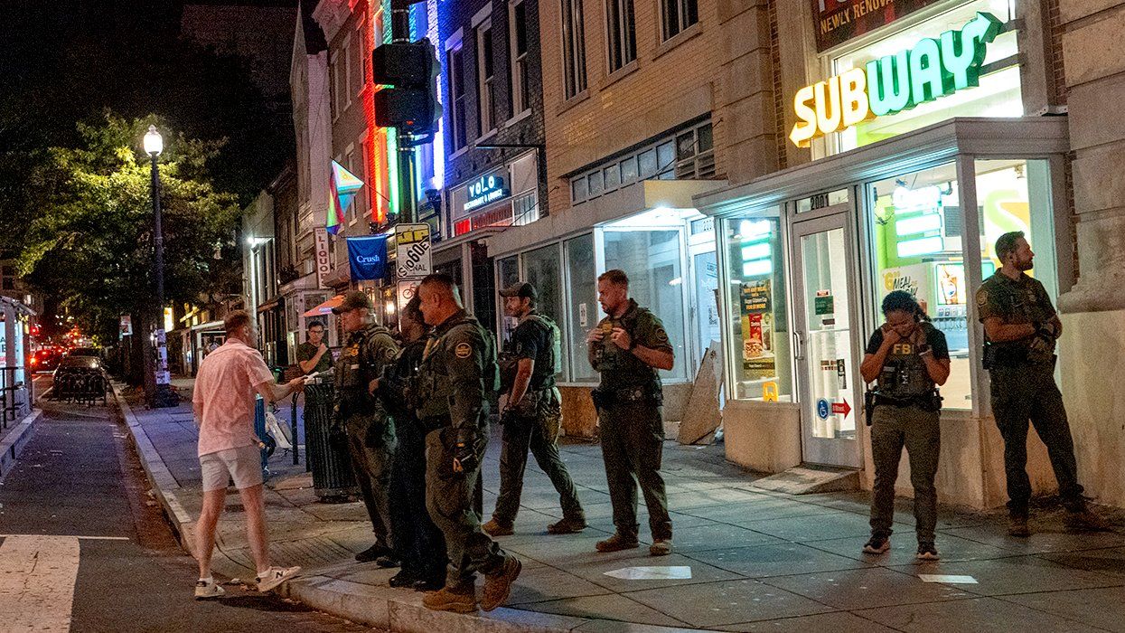 FBI and Border Patrol officers confront a man along the U Street corridor