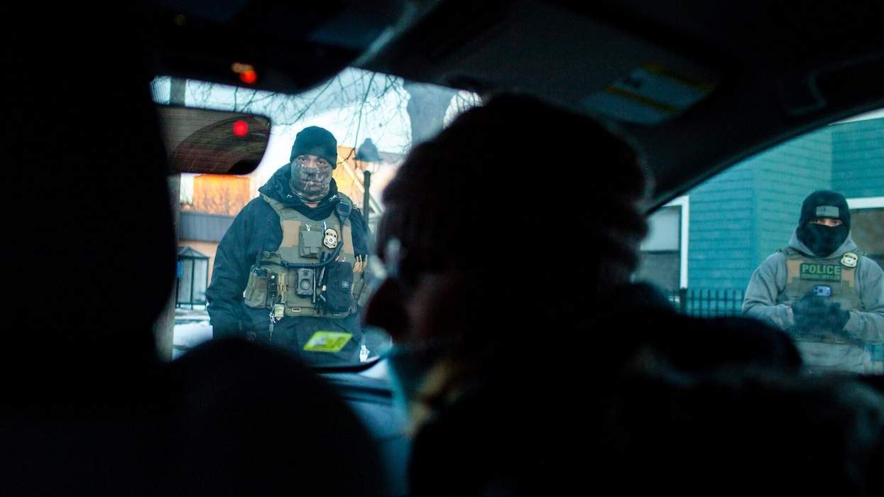 Federal officers outside a car