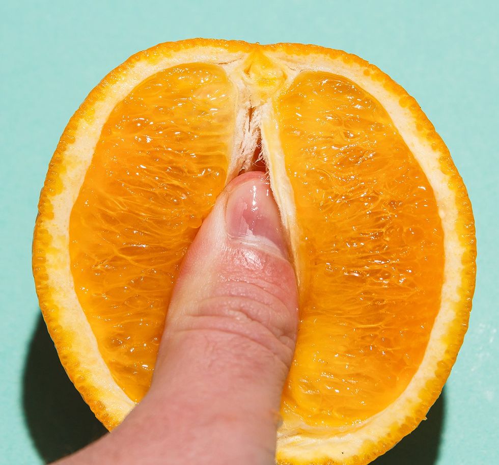 finger in the juicy pulp of an orange